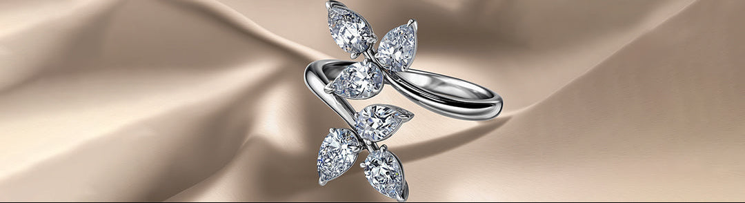 Silver butterfly-shaped ring on a beige satin background