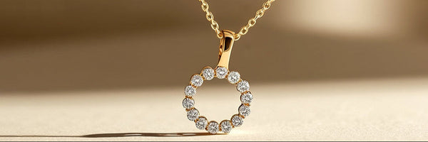 Gold necklace with a round pendant on a beige background