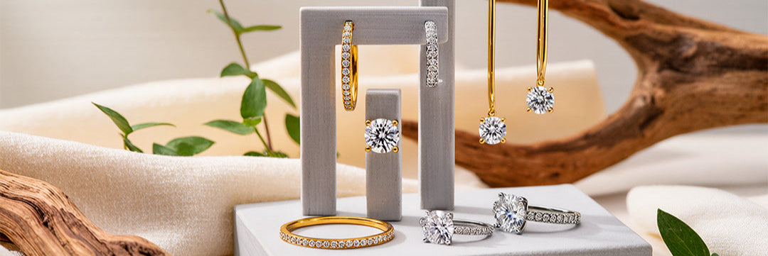 Jewelry display with rings and earrings on a neutral background