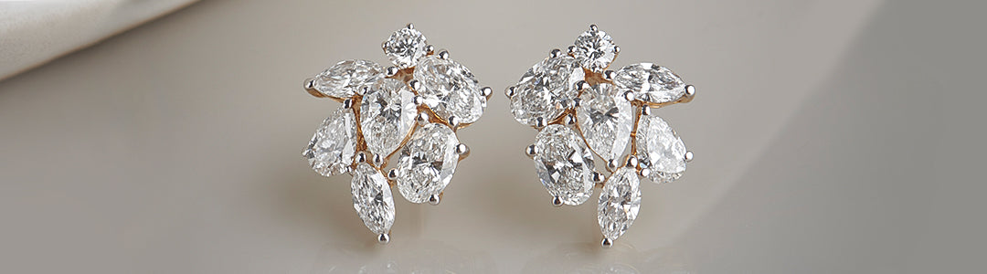 Pair of diamond earrings on a neutral background