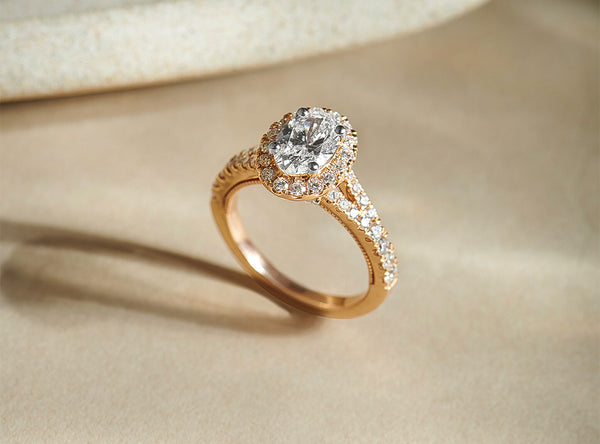 Rose gold ring with a diamond on a beige background