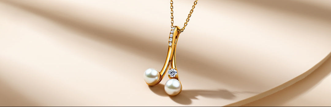 Gold necklace with pearl pendant on a beige background